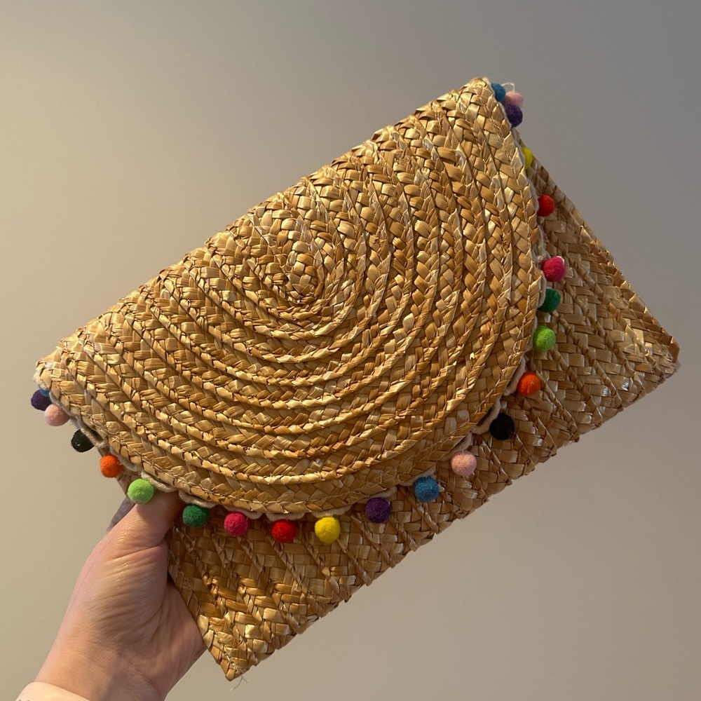 Francesca’s Rainbow Pom-pom Woven Rattan Clutch